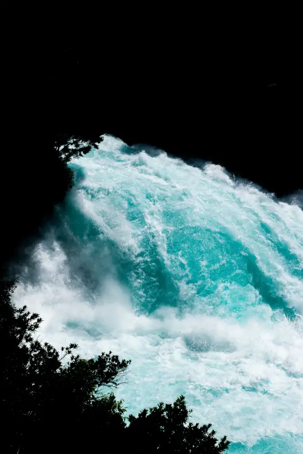 White water falling through darkness